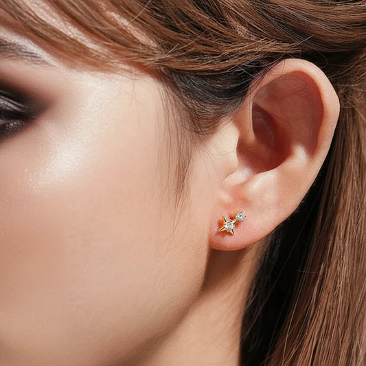 Close-up of an ear wearing a gold earring with a '925 Sterling Silver' stamp.