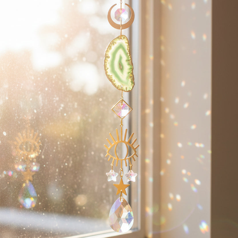 Decorative hanging ornament with gemstone and crystal elements on a white background