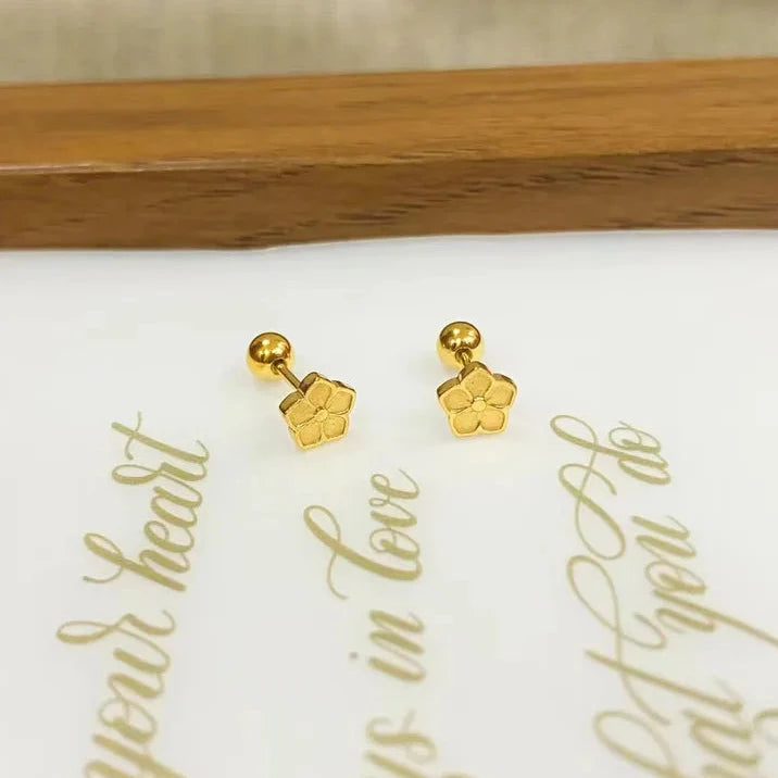 Gold earrings on a card with romantic text